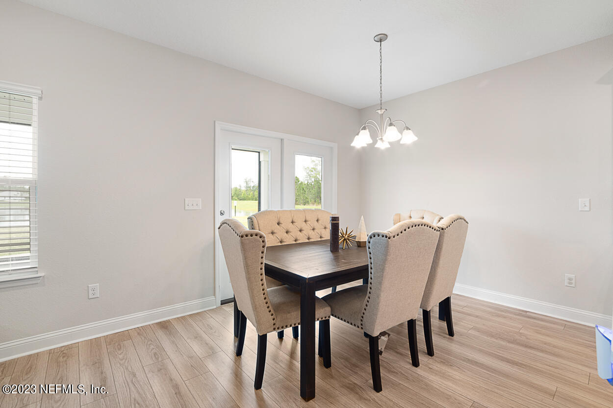 13186 Dunwick Road Jacksonville, FL 32256 - Photo 10 of 48 a view of a dining room with furniture and wooden floor
