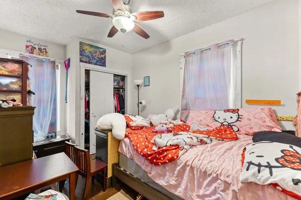 a bedroom with a bed and a desk