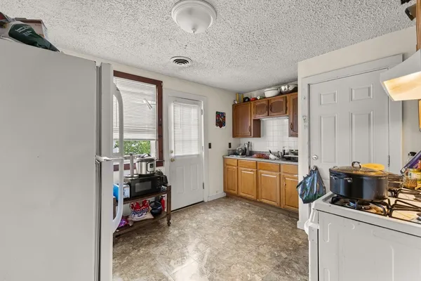 a kitchen that has a lot of cabinets and appliances