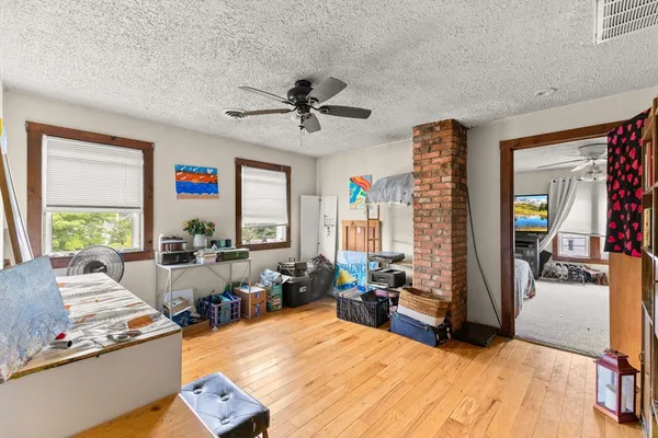 a living room with furniture windows and a flat screen tv