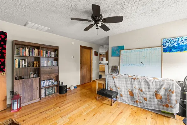 a bedroom with a bed and a book shelf