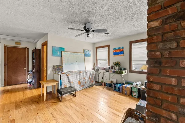a bedroom with furniture and a wooden floor