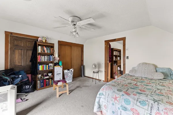 a bedroom with a bed and a book shelf