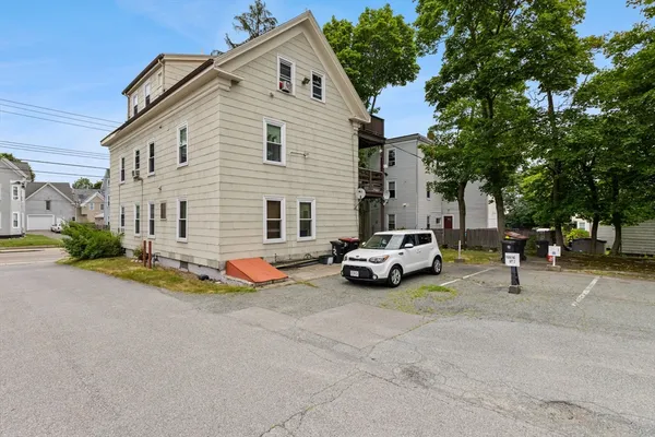 a view of a house with a yard and sitting area