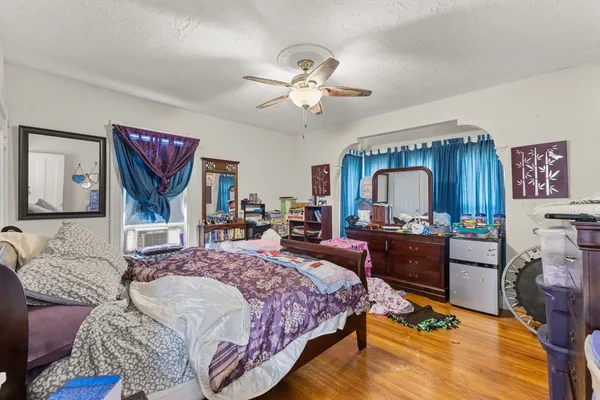 a bedroom with a large bed and a chandelier