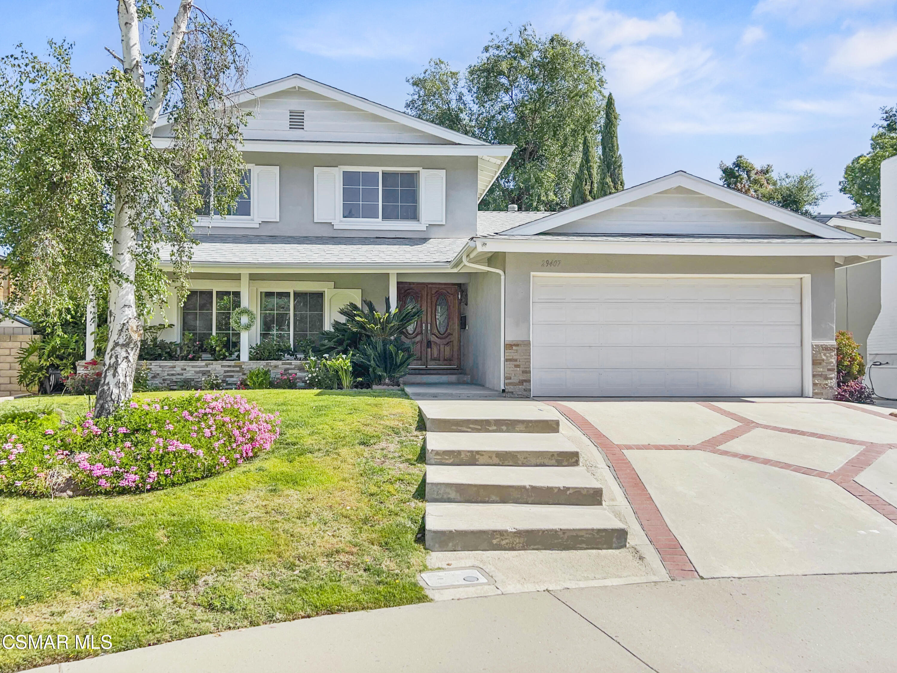 29407 Promontory Place Agoura Hills, CA 91301 - Photo 1 of 26 a front view of a house with garden