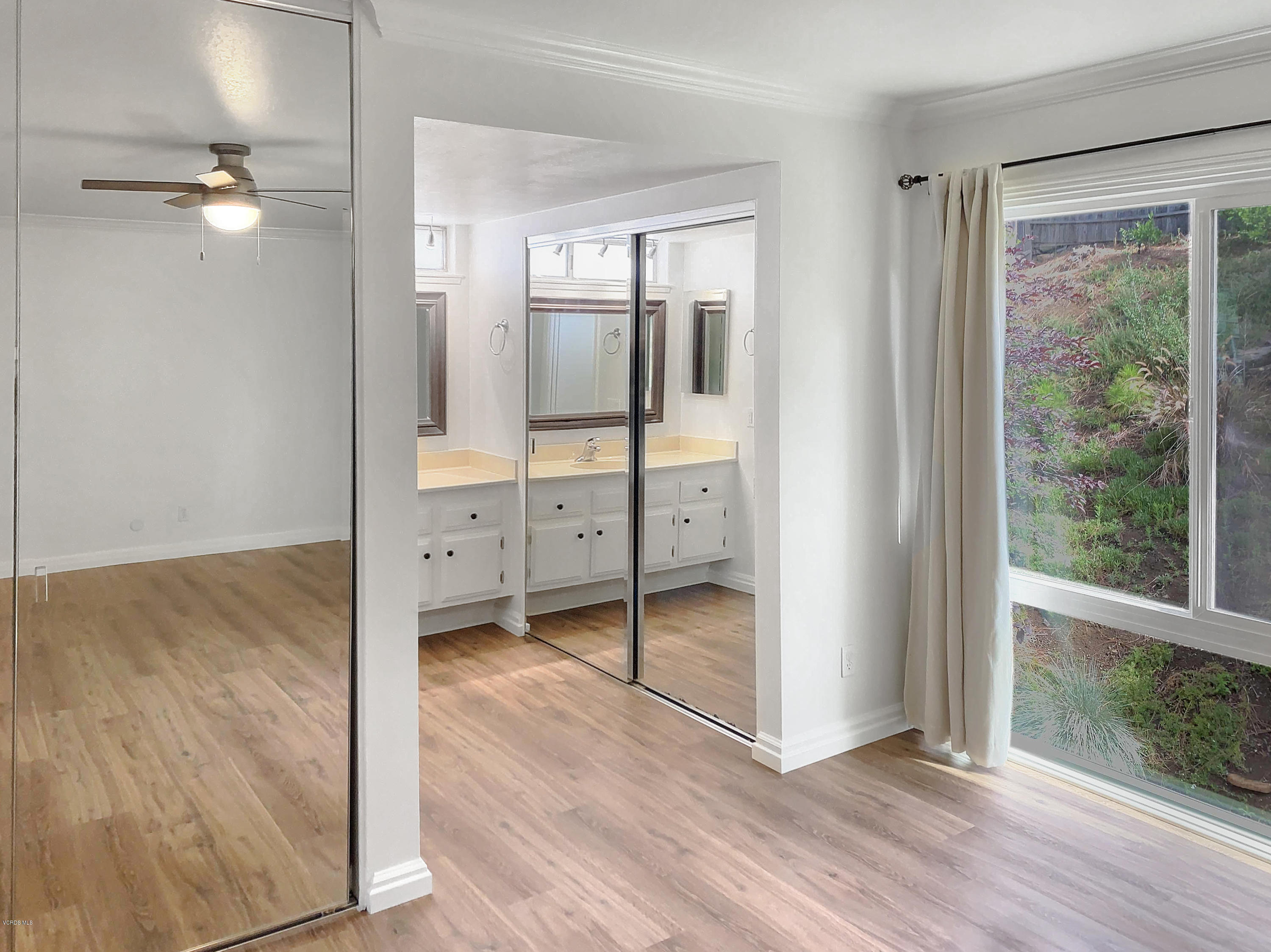 29407 Promontory Place Agoura Hills, CA 91301 - Photo 11 of 26 an empty room with wooden floor and windows