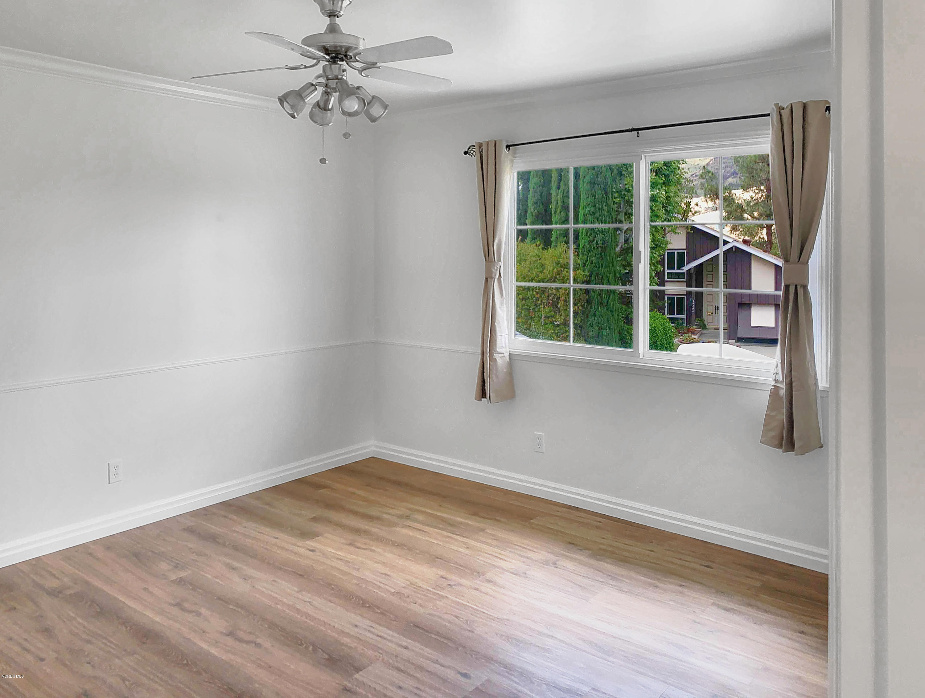 29407 Promontory Place Agoura Hills, CA 91301 - Photo 14 of 26 wooden floor in an empty room with a window