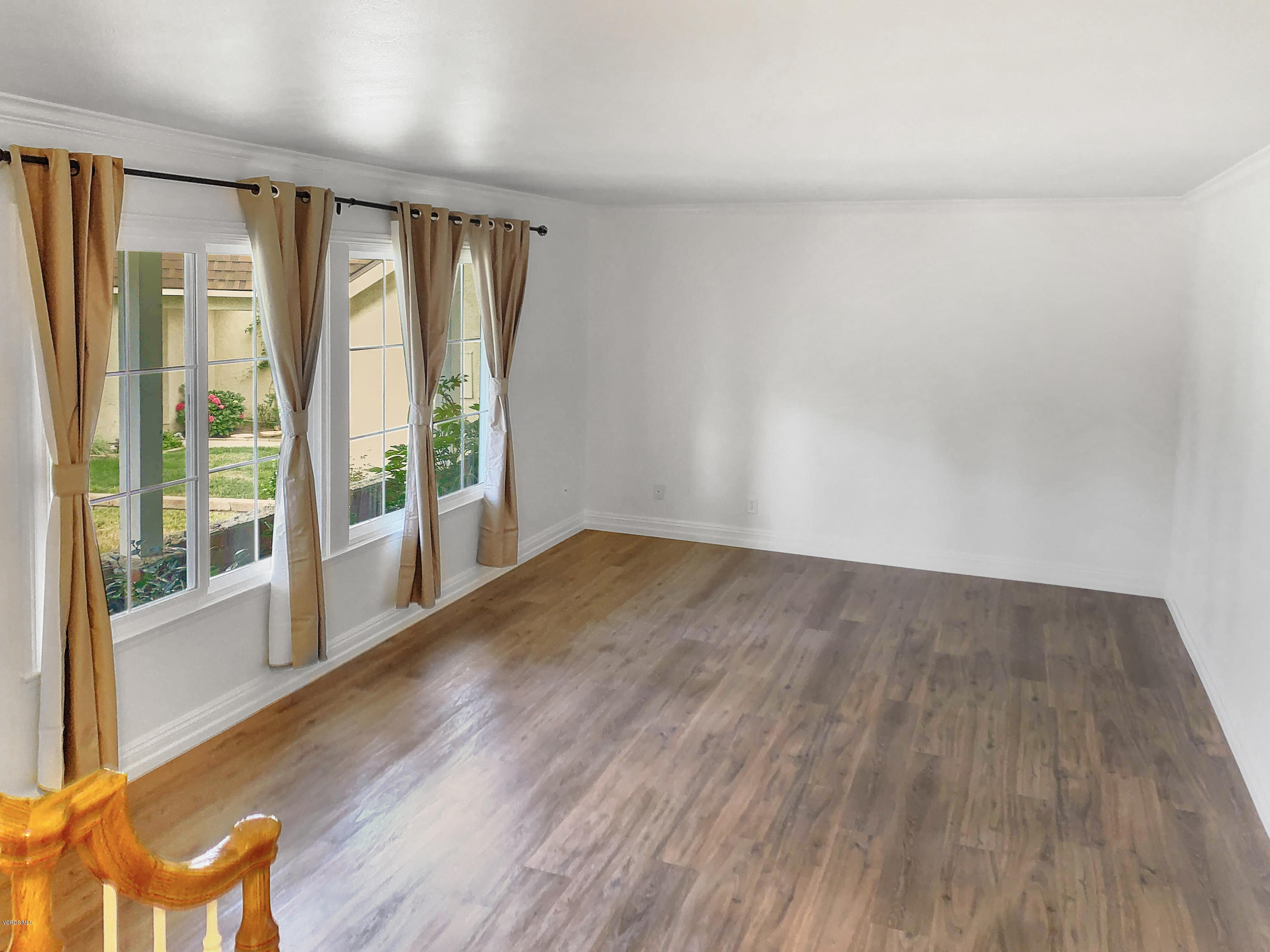 29407 Promontory Place Agoura Hills, CA 91301 - Photo 3 of 26 an empty room with wooden floor and windows