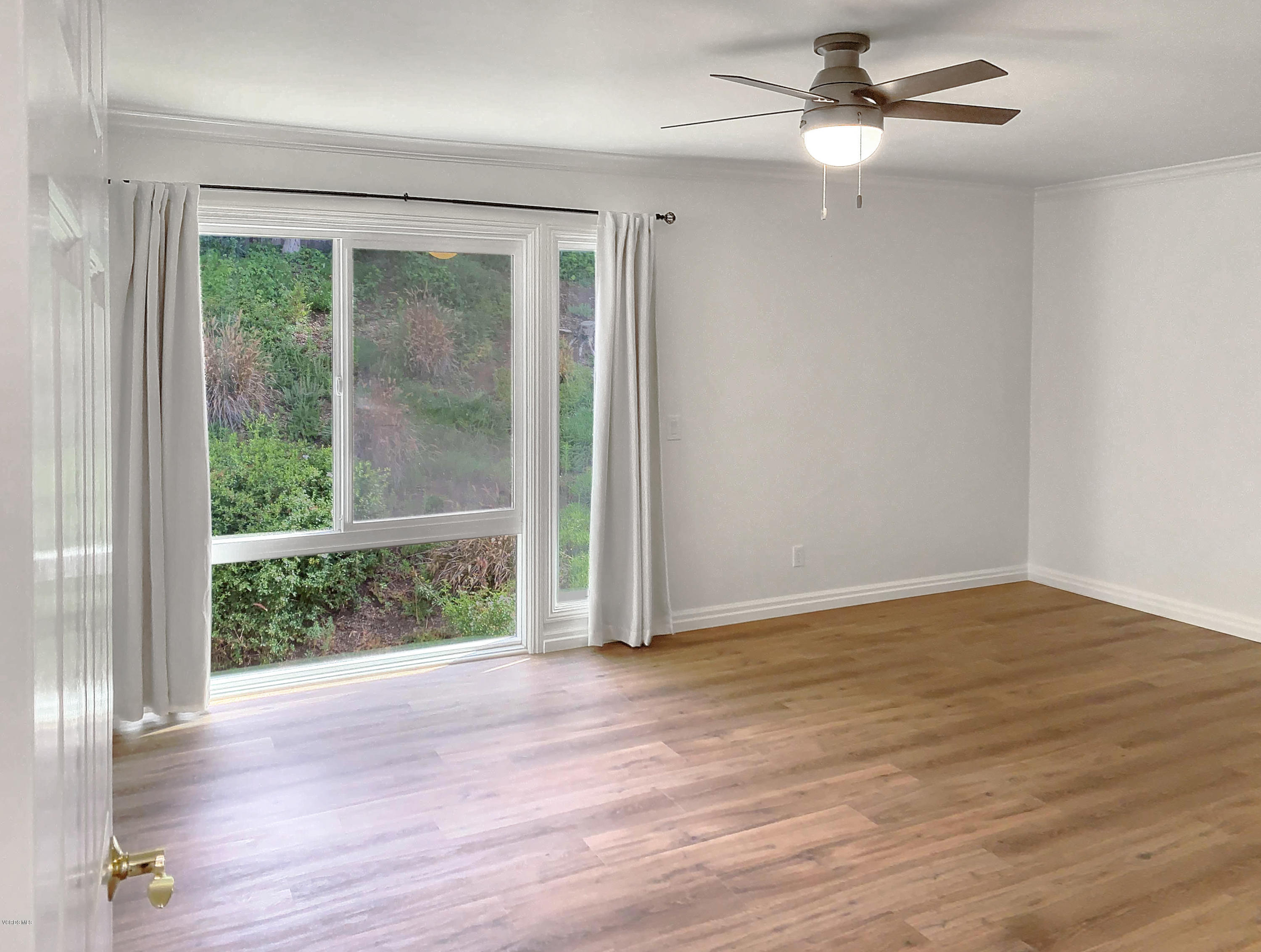 29407 Promontory Place Agoura Hills, CA 91301 - Photo 9 of 26 a view of an empty room with wooden floor and a window