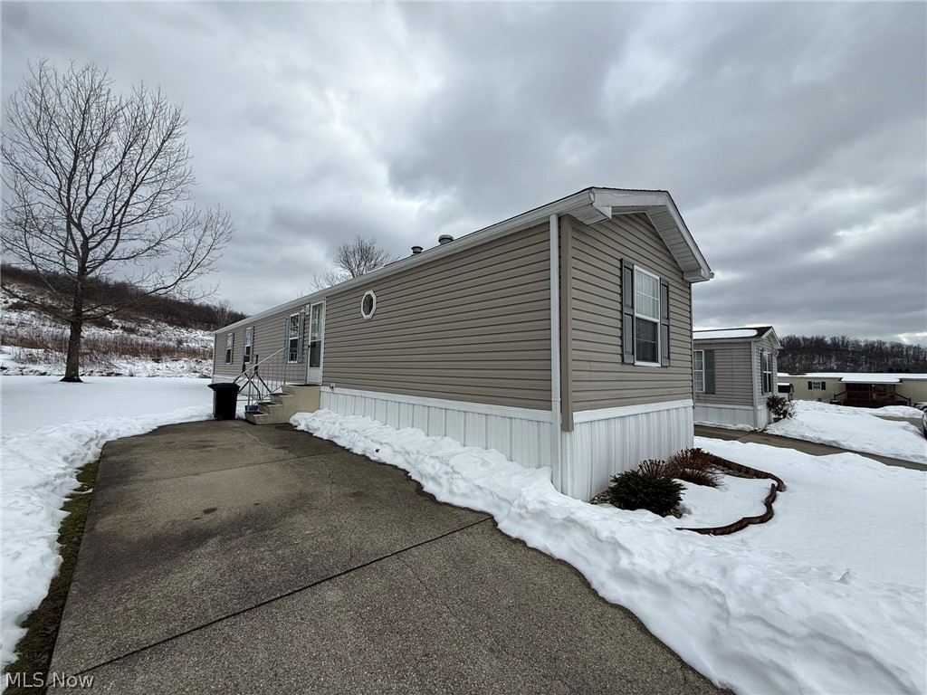 2933 Rabbit Drive Dennison, OH 44621 - Photo 2 of 28 Snow covered property featuring entry steps