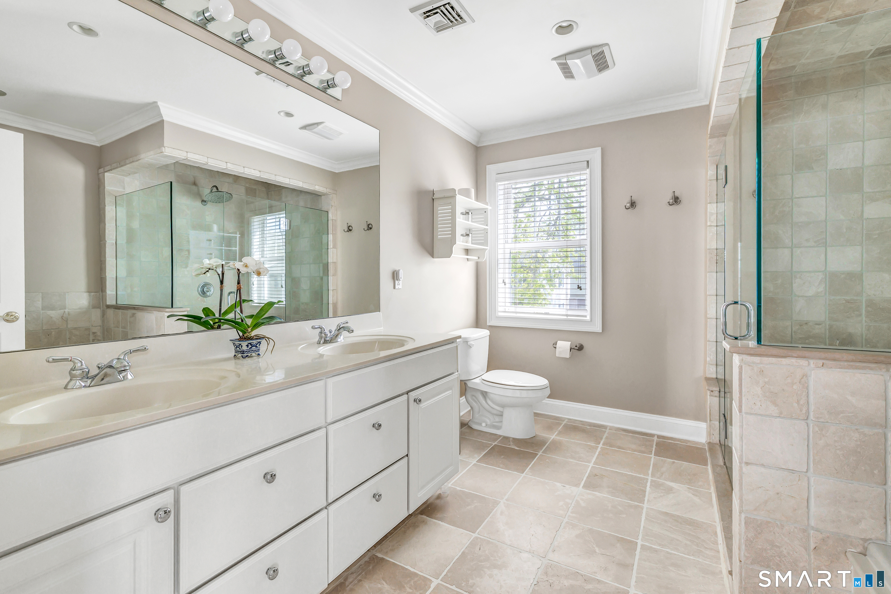 39 Maple Tree Avenue, Unit 15 Stamford, CT 06906 - Photo 13 of 32 a spacious bathroom with a double vanity sink a large mirror and a toilet