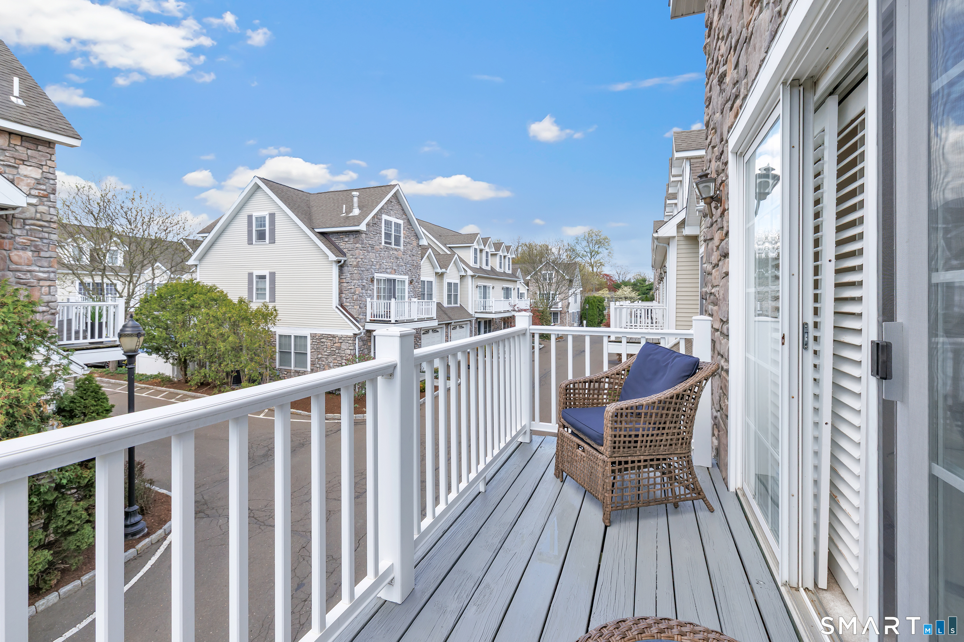 39 Maple Tree Avenue, Unit 15 Stamford, CT 06906 - Photo 16 of 32 a view of a balcony with wooden chairs