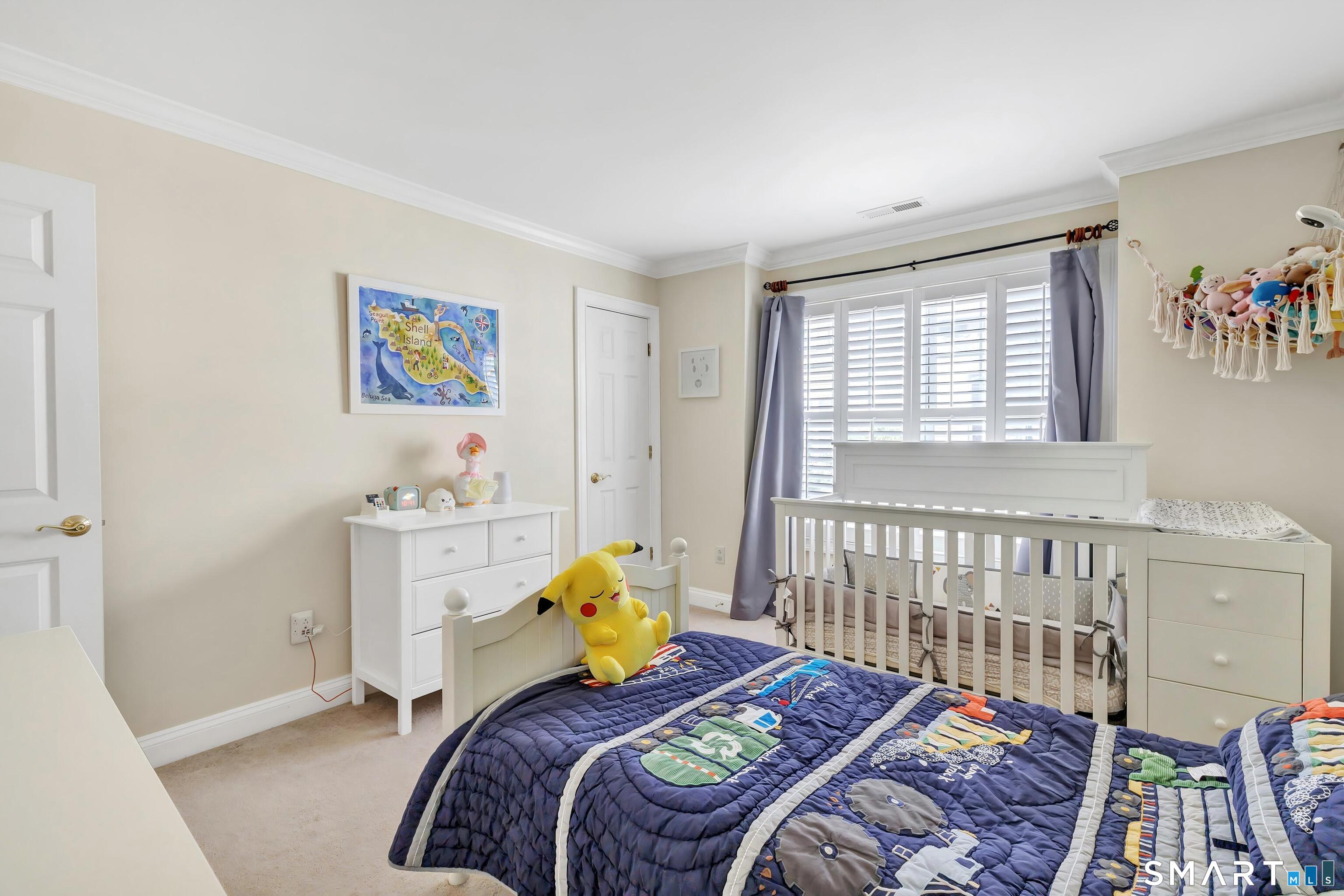 39 Maple Tree Avenue, Unit 15 Stamford, CT 06906 - Photo 19 of 32 a bedroom with a bed and a window