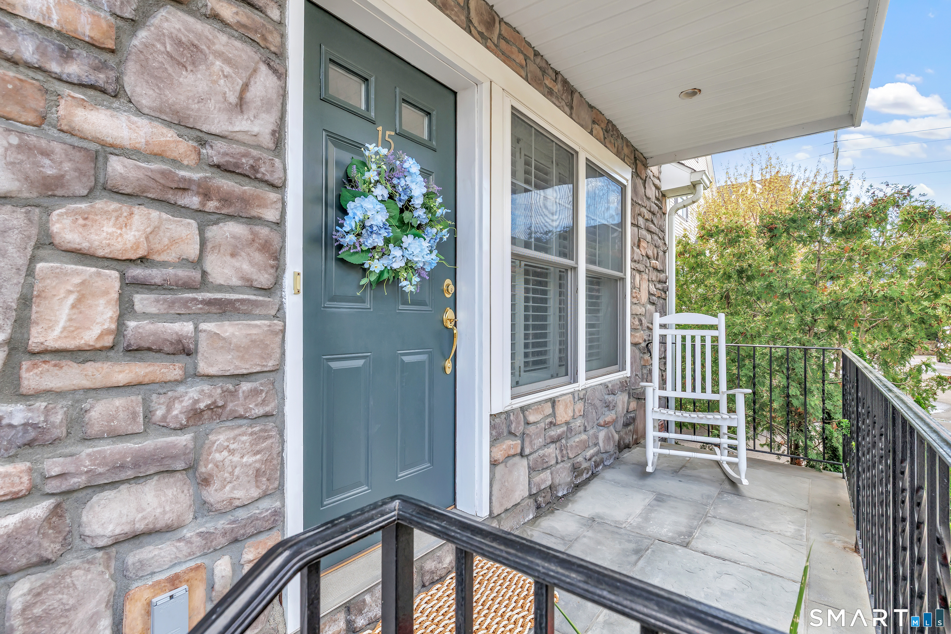 39 Maple Tree Avenue, Unit 15 Stamford, CT 06906 - Photo 4 of 32 a view of a porch with a chair and table
