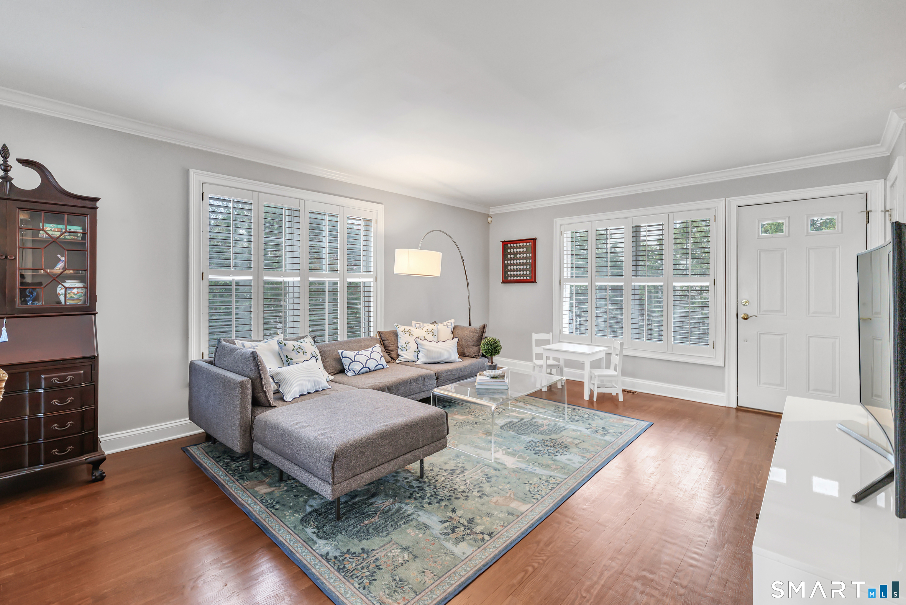 39 Maple Tree Avenue, Unit 15 Stamford, CT 06906 - Photo 6 of 32 a living room with furniture and a large window