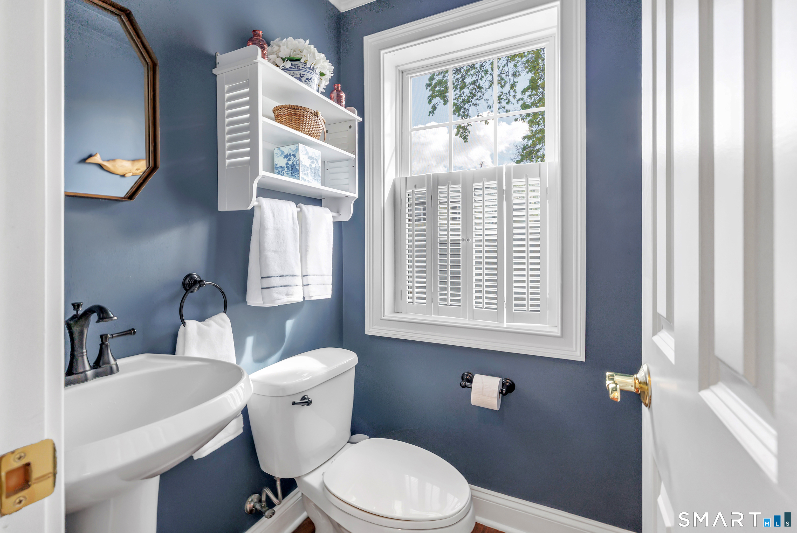 39 Maple Tree Avenue, Unit 15 Stamford, CT 06906 - Photo 10 of 32 a white toilet sitting next to a bathroom sink