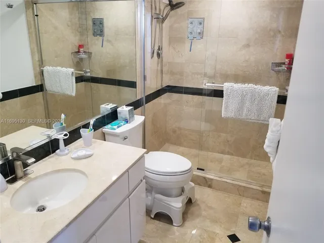 a living room with furniture and large windows