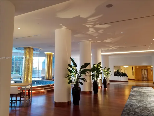 a view of a room with furniture and wooden floor