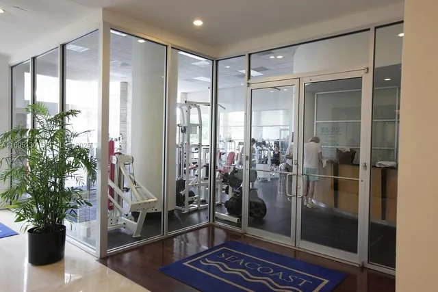 a kitchen with stainless steel appliances granite countertop a refrigerator a sink and a stove