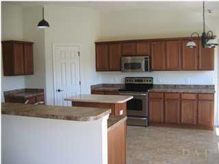 Large kitchen with upgraded appliances and lighting