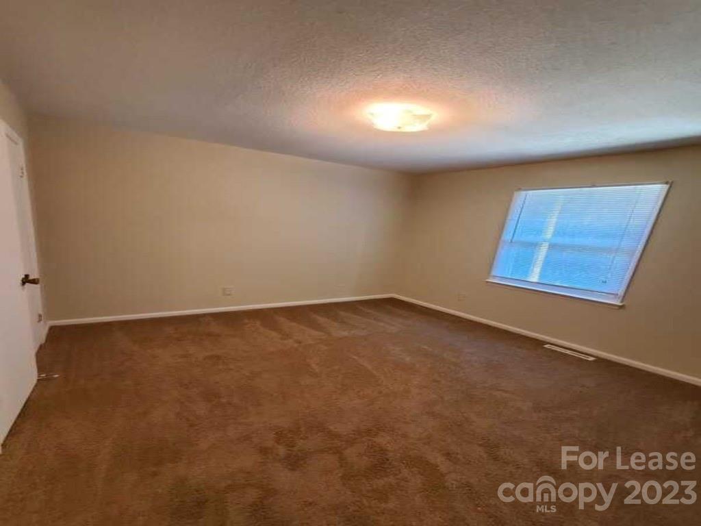 1411 Sharon Road Charlotte, NC 28210 - Photo 2 of 5 an empty room with a workbench