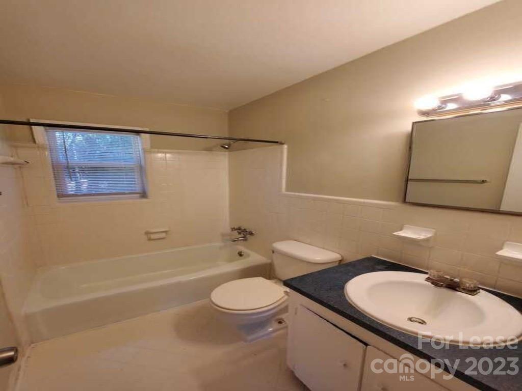 1411 Sharon Road Charlotte, NC 28210 - Photo 3 of 5 a bathroom with a sink a toilet and shower