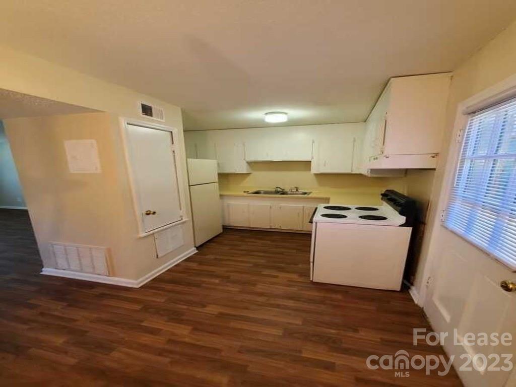 1411 Sharon Road Charlotte, NC 28210 - Photo 5 of 5 a room with kitchen island a sink and a stove top oven