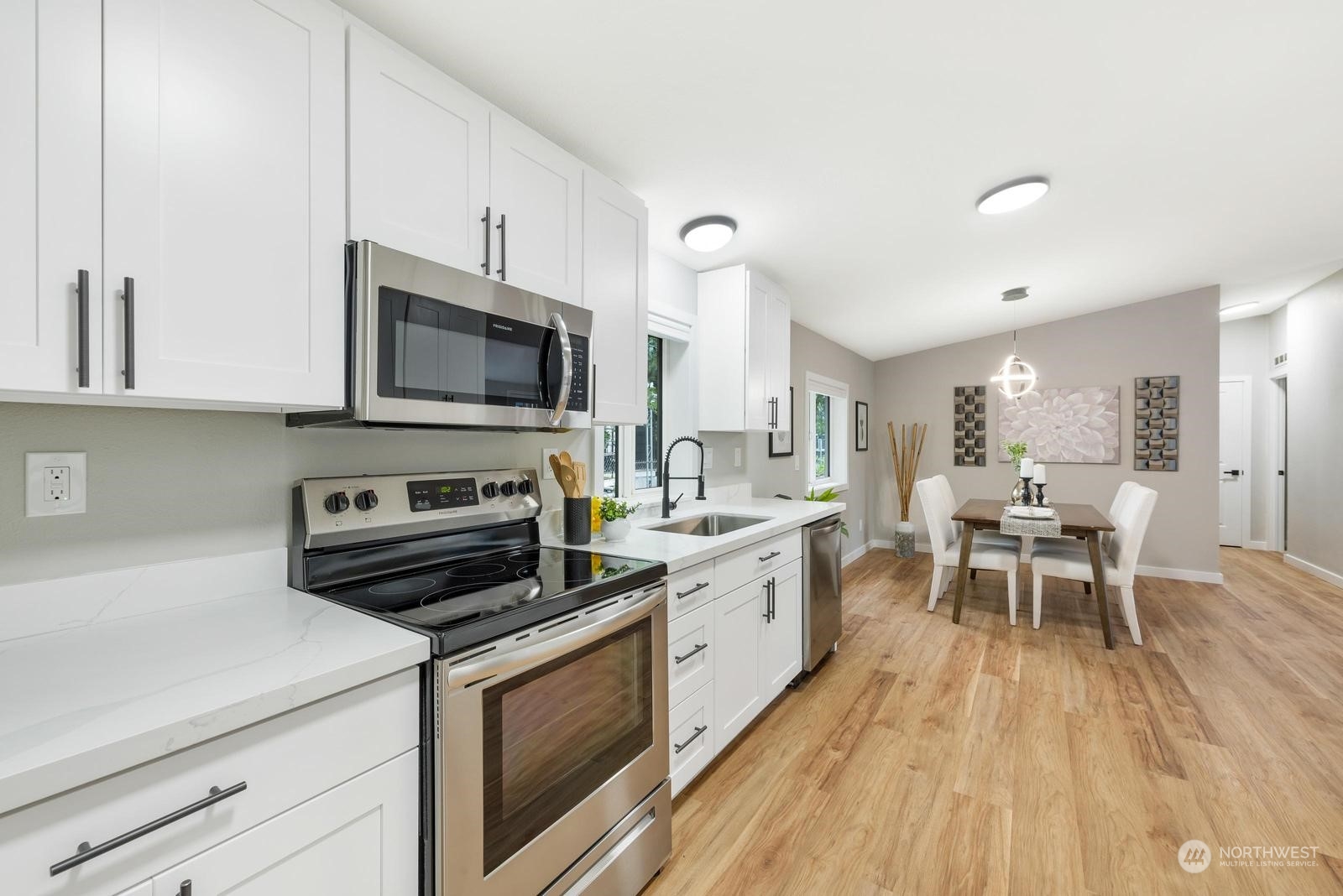20500 32nd Drive Southeast Bothell, WA 98012 - Photo 6 of 28 a kitchen with a table chairs microwave and cabinets