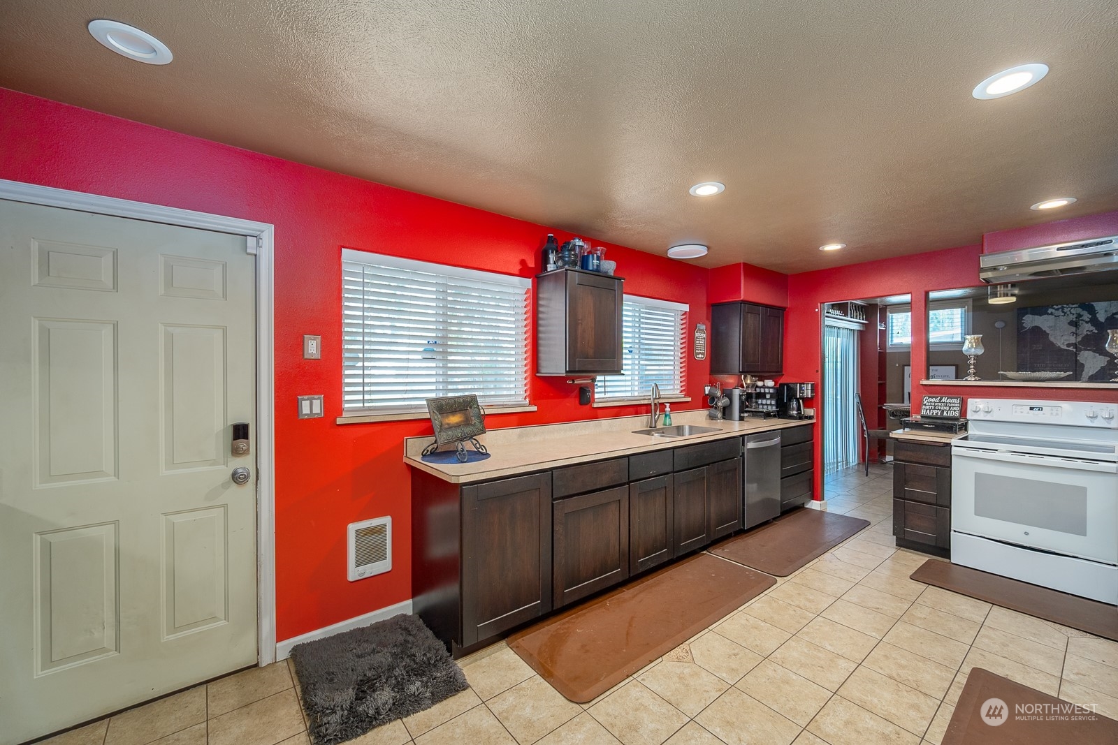 9015 Bong Loop, Unit 9017 Moses Lake, WA 98837 - Photo 13 of 26 a kitchen with stainless steel appliances kitchen island granite countertop a stove a sink and a refrigerator