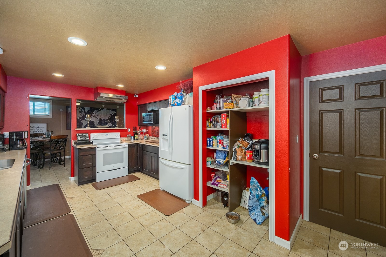 9015 Bong Loop, Unit 9017 Moses Lake, WA 98837 - Photo 15 of 26 a kitchen with stainless steel appliances kitchen island granite countertop a refrigerator and a stove