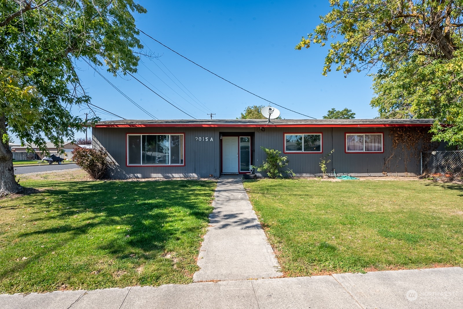 9015 Bong Loop, Unit 9017 Moses Lake, WA 98837 - Photo 2 of 26 a front view of a house with garden