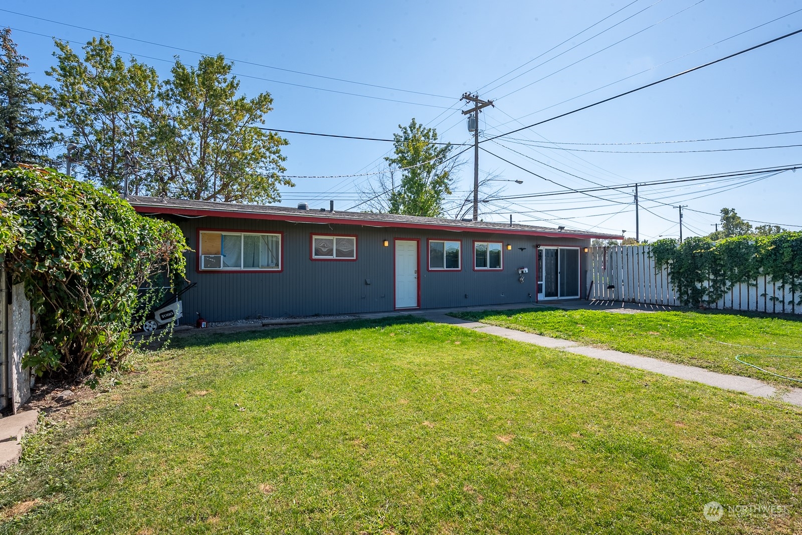 9015 Bong Loop, Unit 9017 Moses Lake, WA 98837 - Photo 21 of 26 a view of a house with a backyard and plants