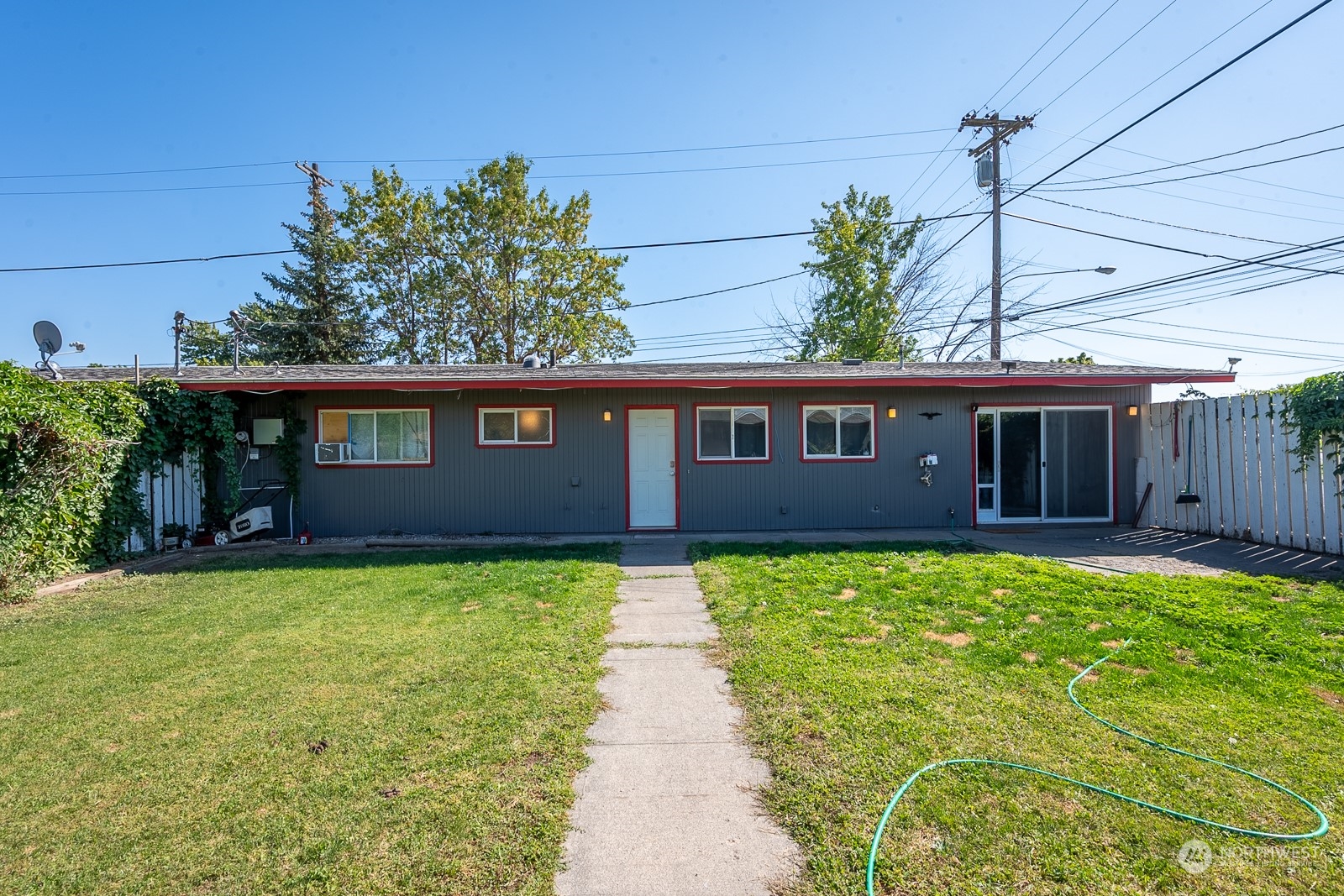 9015 Bong Loop, Unit 9017 Moses Lake, WA 98837 - Photo 22 of 26 a front view of a house with a garden