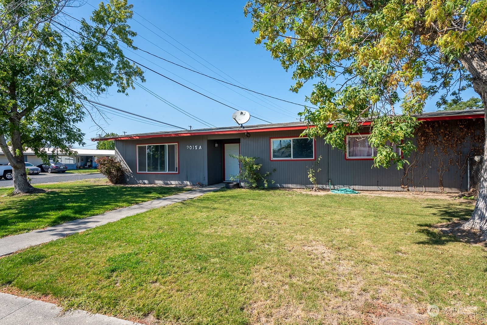 9015 Bong Loop, Unit 9017 Moses Lake, WA 98837 - Photo 3 of 26 a front view of a house with a yard