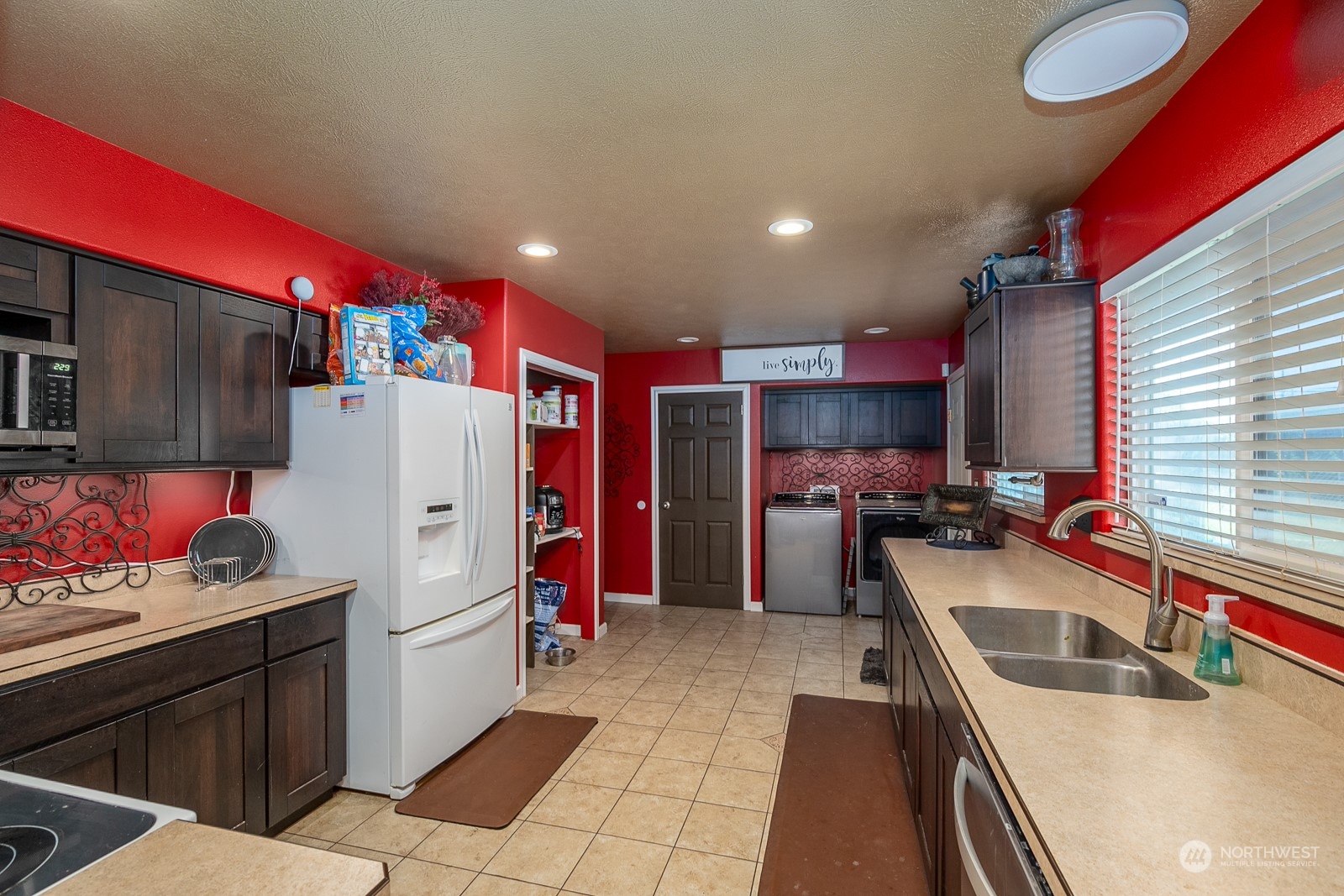 9015 Bong Loop, Unit 9017 Moses Lake, WA 98837 - Photo 10 of 26 a kitchen with stainless steel appliances granite countertop a sink refrigerator and cabinets