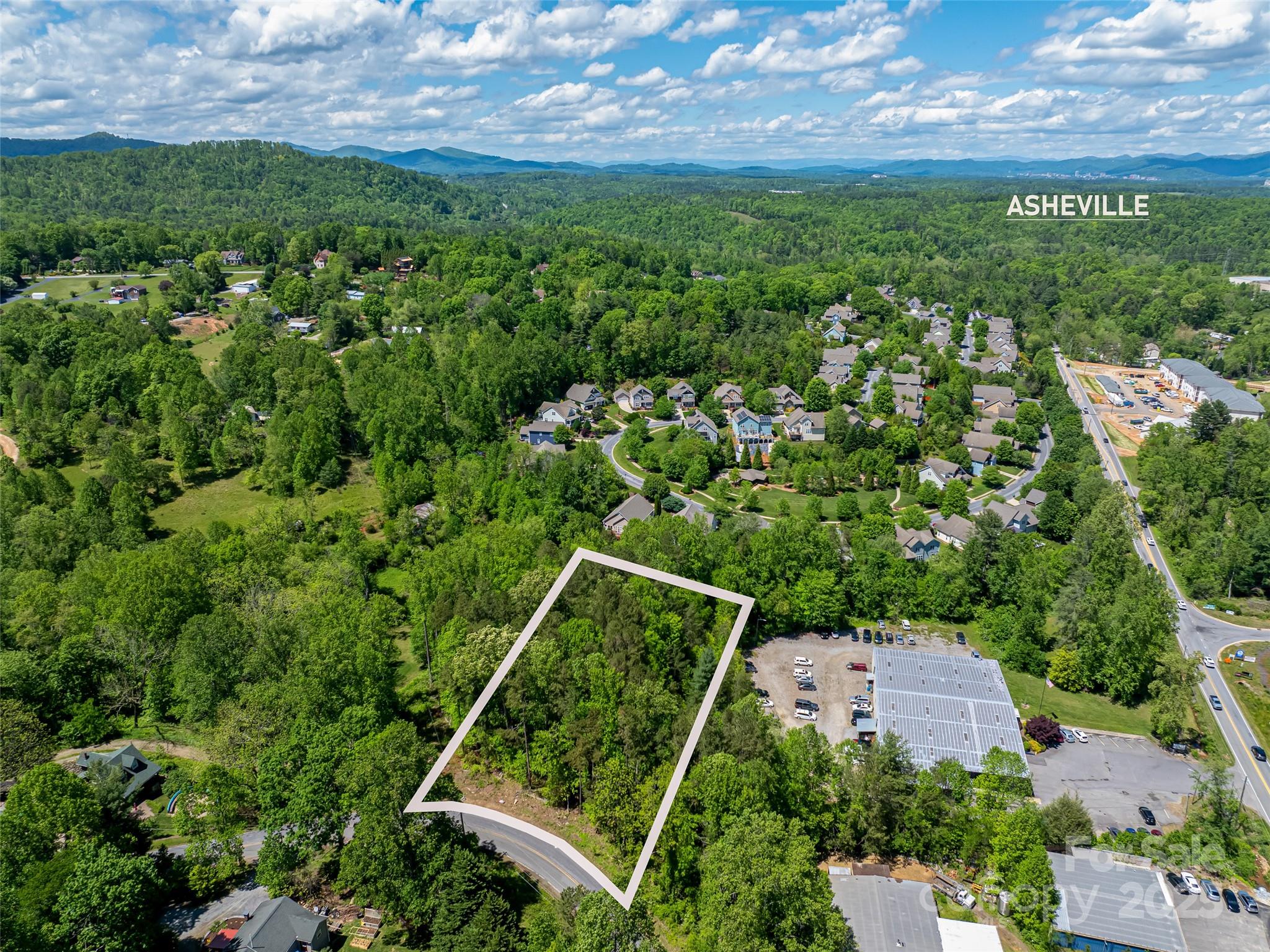 99999 Brevard Road Mills River, NC 28759 - Photo 2 of 13 an aerial view of residential houses with outdoor space and trees