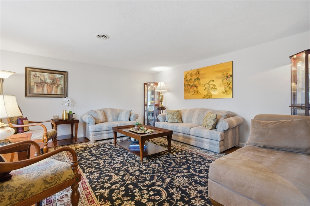 22 Magnolia Road Sharon, MA 02067 - Photo 15 of 42 a living room with furniture and painting on the wall
