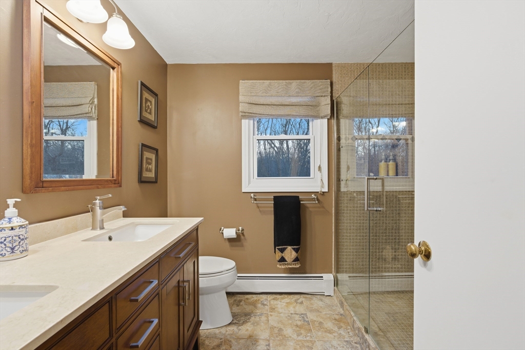 22 Magnolia Road Sharon, MA 02067 - Photo 24 of 42 a bathroom with a sink and a mirror