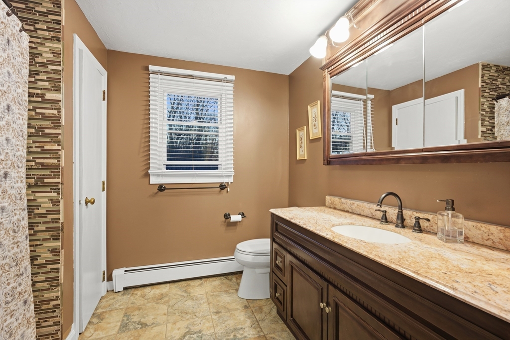 22 Magnolia Road Sharon, MA 02067 - Photo 25 of 42 a bathroom with a sink a toilet and a window