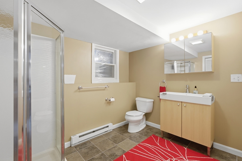 22 Magnolia Road Sharon, MA 02067 - Photo 27 of 42 a bathroom with a toilet a sink and a mirror