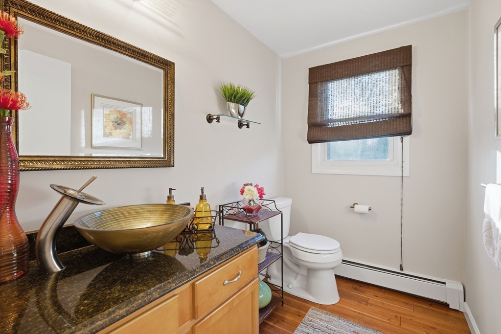 22 Magnolia Road Sharon, MA 02067 - Photo 28 of 42 a bathroom with a toilet a sink and a mirror