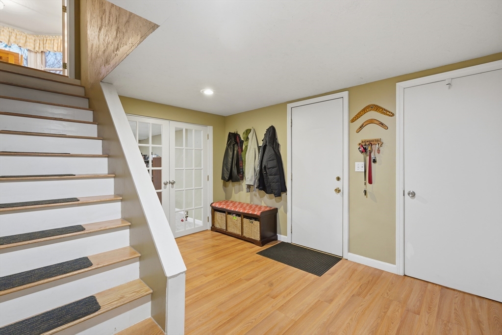 22 Magnolia Road Sharon, MA 02067 - Photo 29 of 42 a view of a hallway with wooden floor and staircase