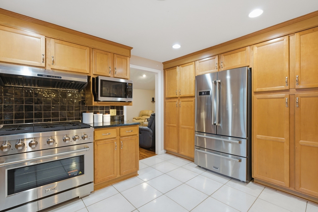 22 Magnolia Road Sharon, MA 02067 - Photo 3 of 42 a kitchen with stainless steel appliances granite countertop a refrigerator stove and microwave