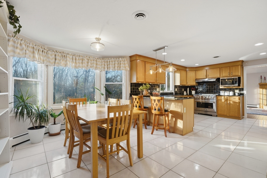 22 Magnolia Road Sharon, MA 02067 - Photo 7 of 42 a dining hall with stainless steel appliances a dining table and chairs