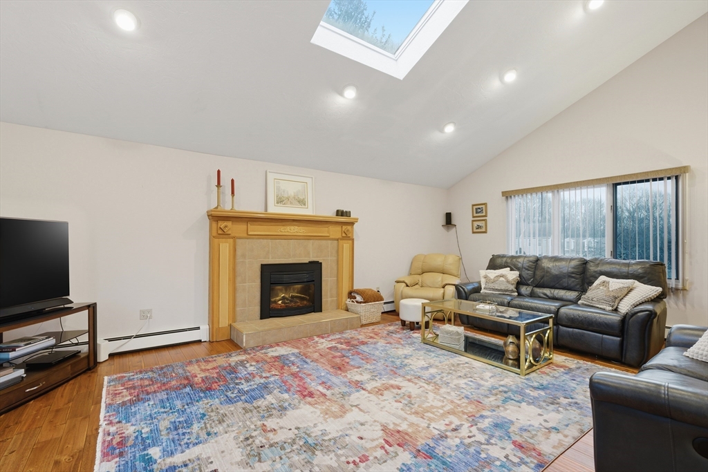 22 Magnolia Road Sharon, MA 02067 - Photo 10 of 42 a living room with furniture and a fireplace