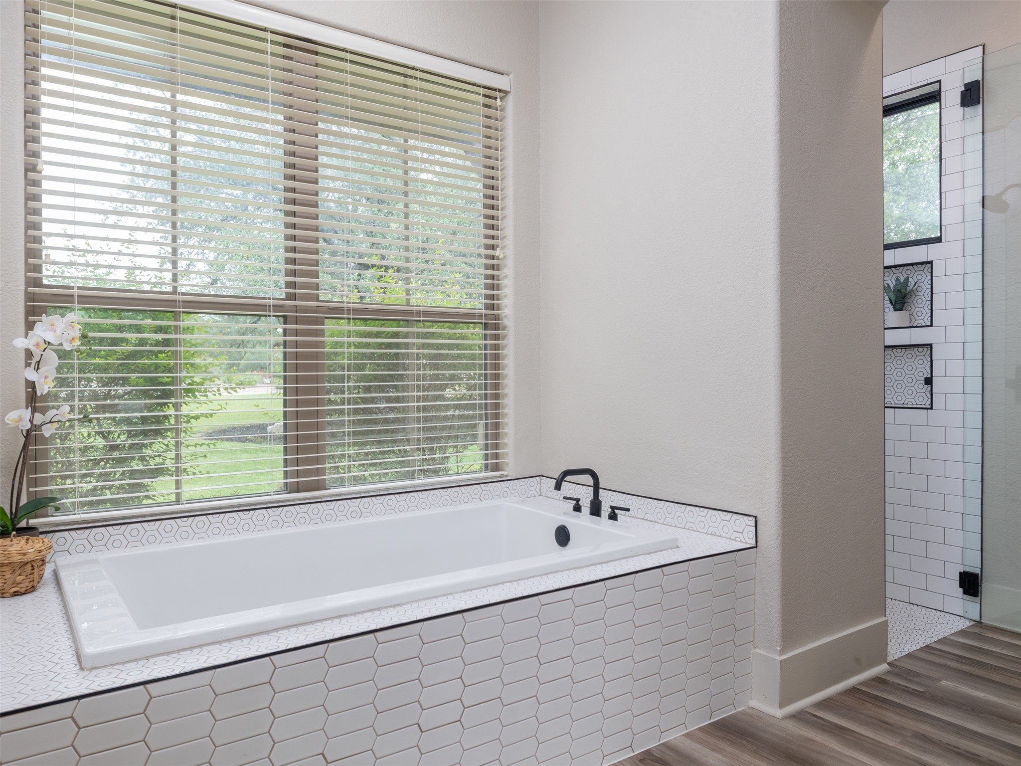 101 Aldea Street Georgetown, TX 78633 - Photo 13 of 40 Enjoy soaking in this oversized tub with a peaceful view of trees and extra countertop space or enjoy the private, updated walk-in shower.