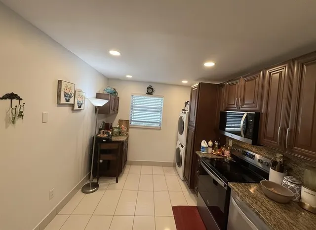 a kitchen with a refrigerator and a stove top oven