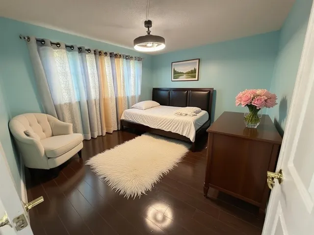 a bedroom with a bed and a couch