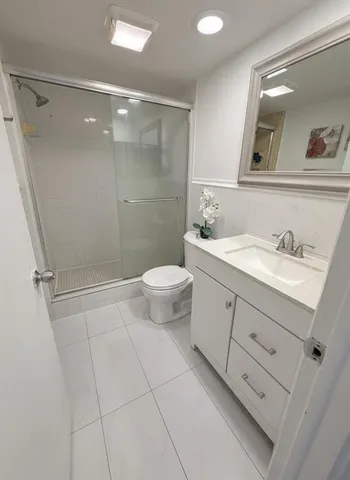 a bathroom with a sink toilet and shower
